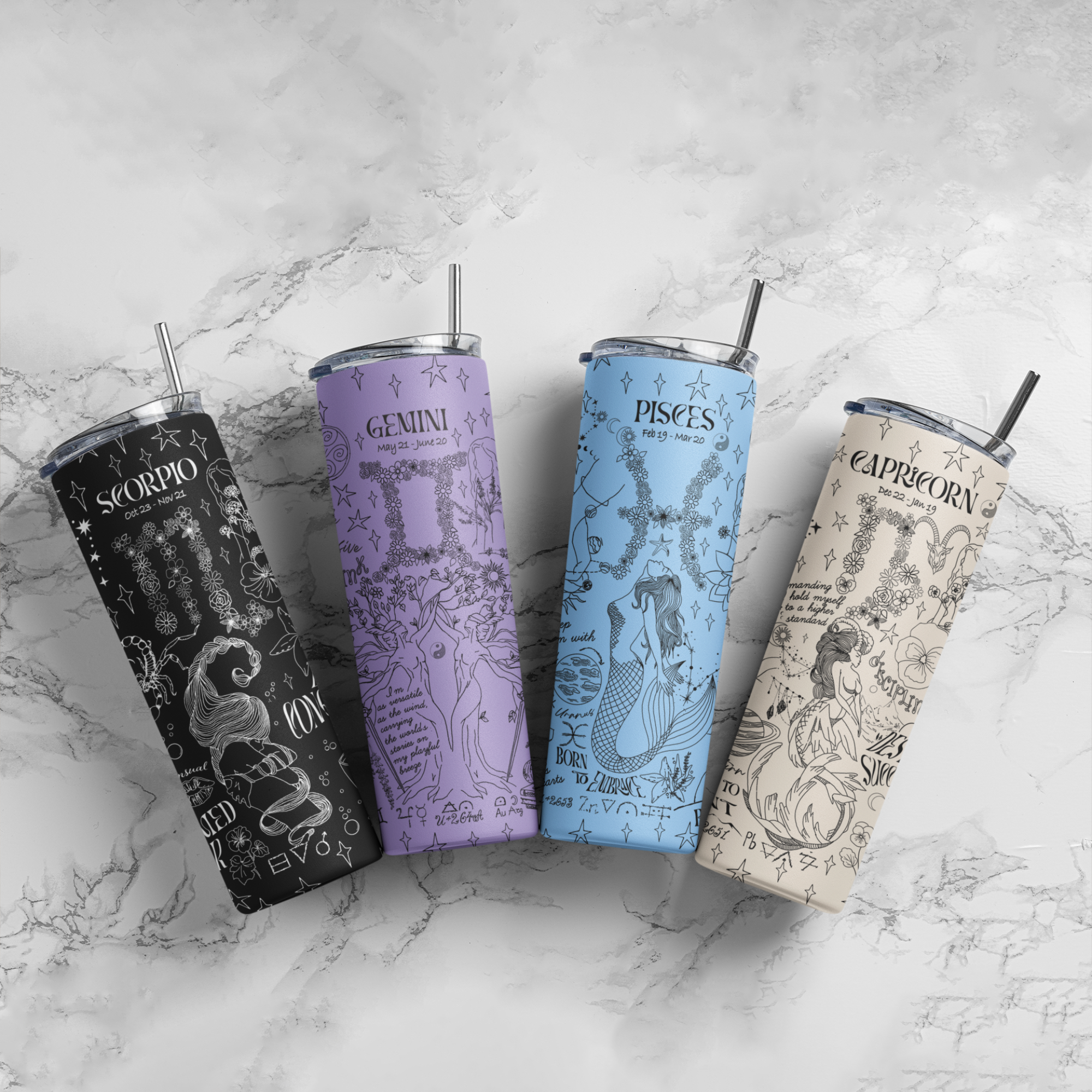a group of four travel mugs sitting on top of a marble counter